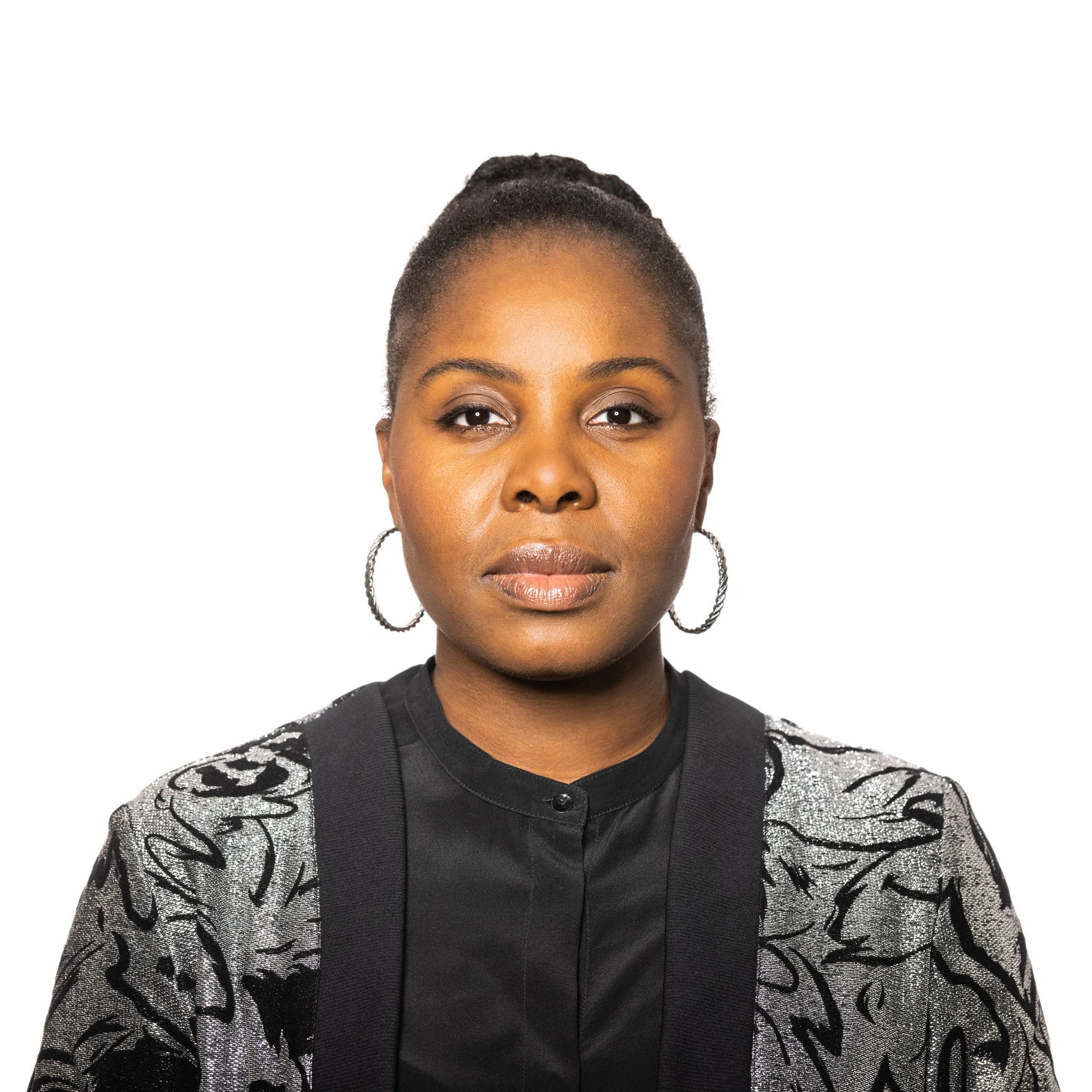 Black woman in her 30s with a calm, welcoming expression